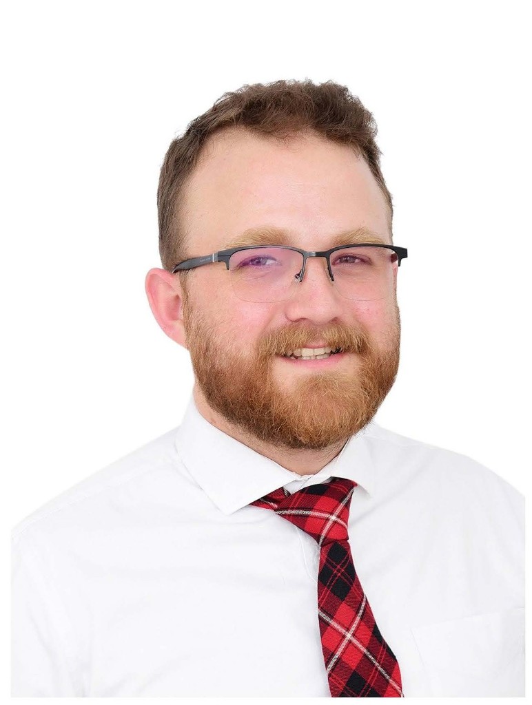 Grant Crossman, founder and lead tutor, in a white shirt and red plaid tie.
